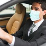 Masked man driving his car